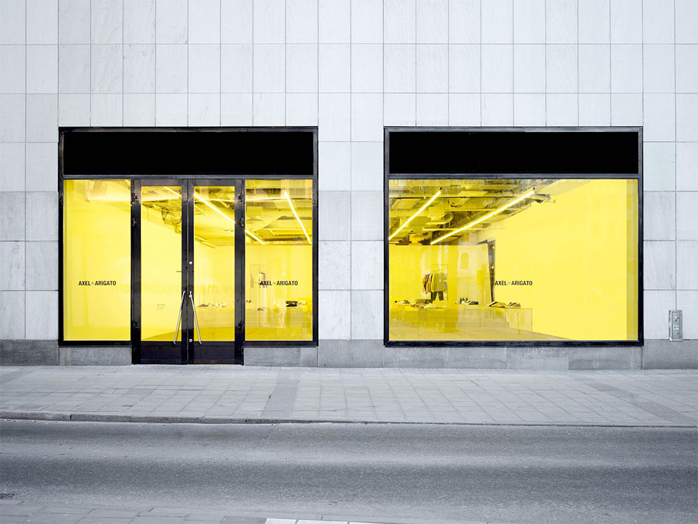 A large storefront with a bright yellow tinge on the interior.