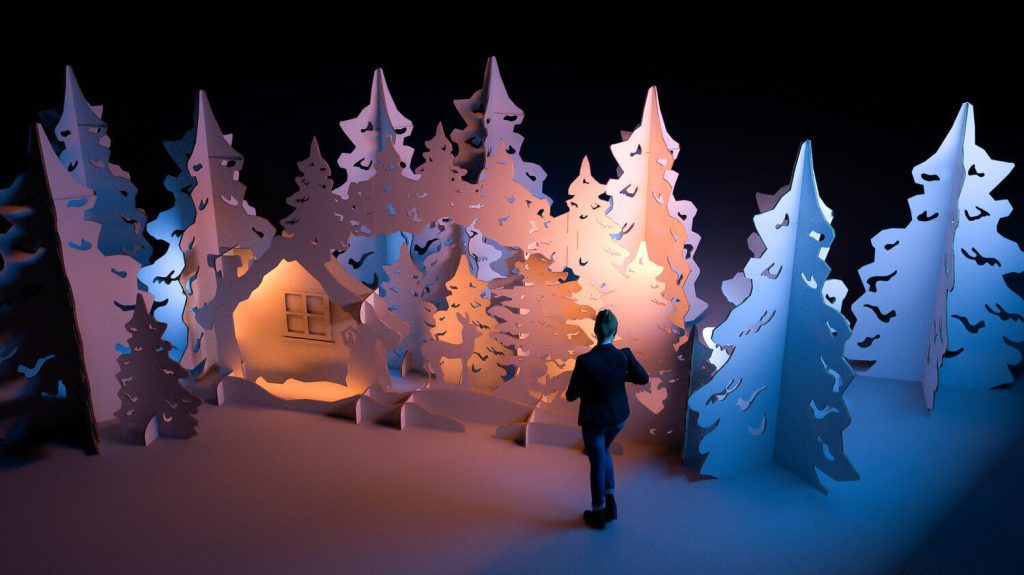 A large dimly lit winter wonderland Re-Board display filled with cardboard trees.