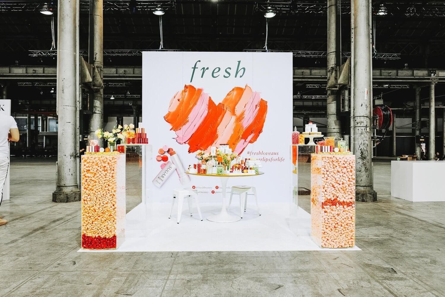 A highly saturated image of Sephora's "Fresh" stand with a few chairs for people to try their new lipstick.