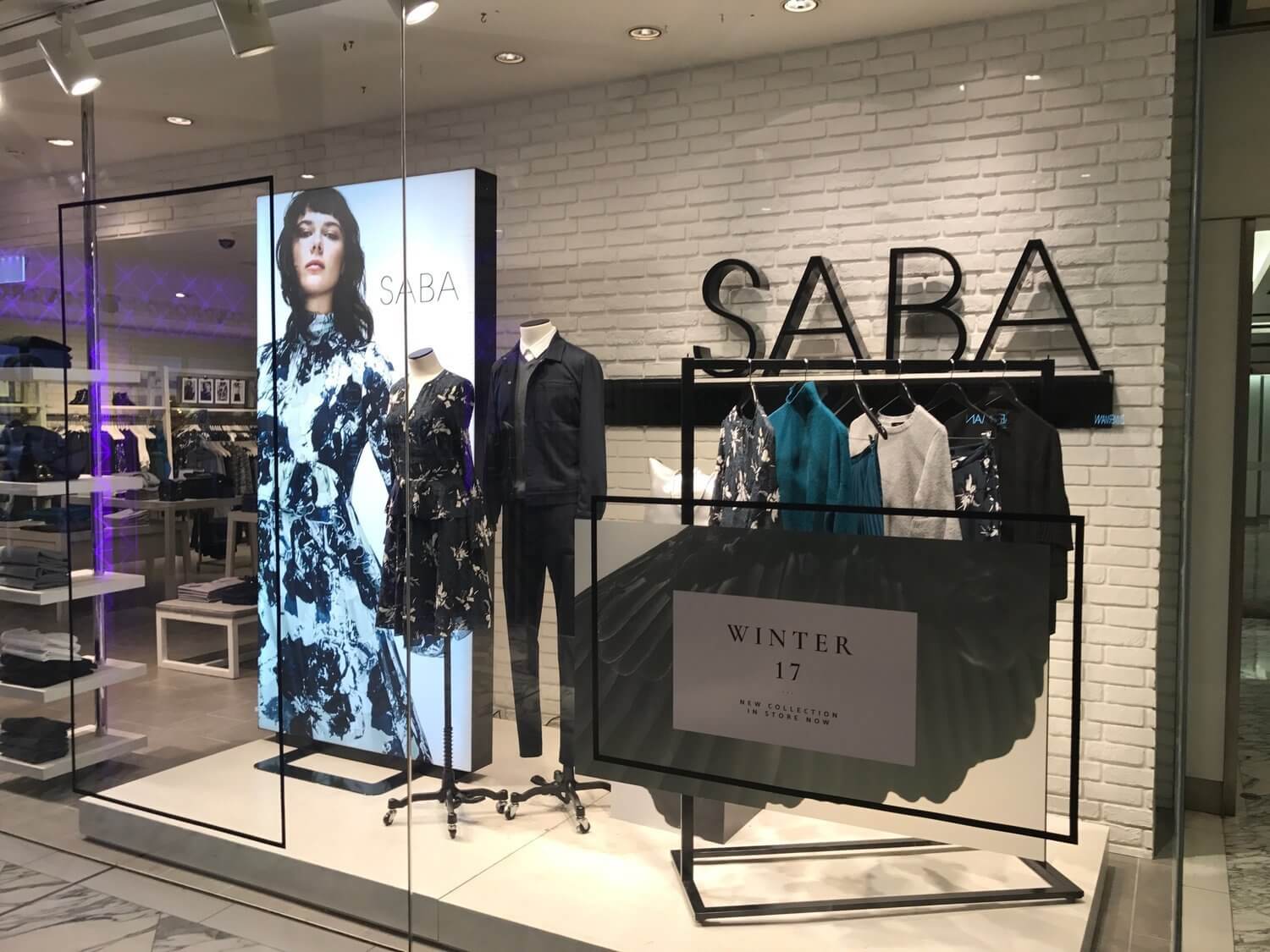 SABA window display including black clothing.