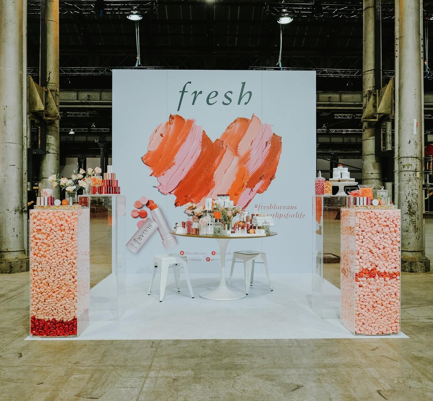 A large Sephora display promoting their lipstick with chairs and products surrounding it, with the text "fresh" in the background.