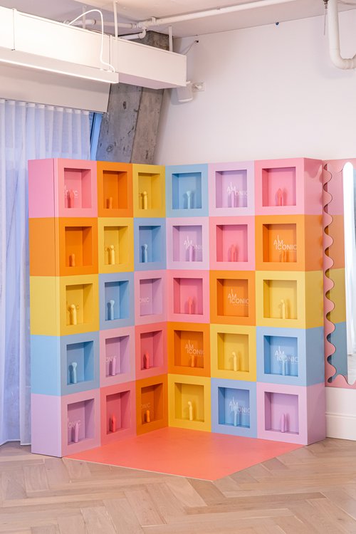 Multicoloured cubical block display with products inside.
