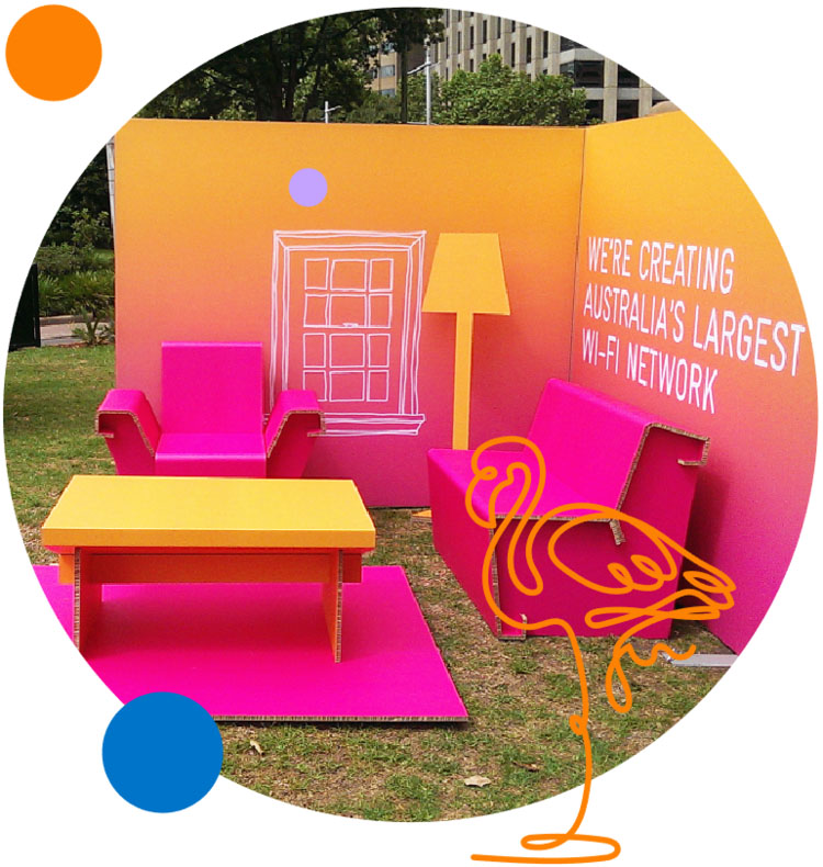 A colourful living room display in the colours of yelow and pink created with Re-Board for Telstra.